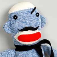 A sock monkey with a twist. A moustache twist.